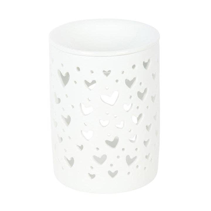 Quemador de cera blanco, con diseño recortado en forma de corazón