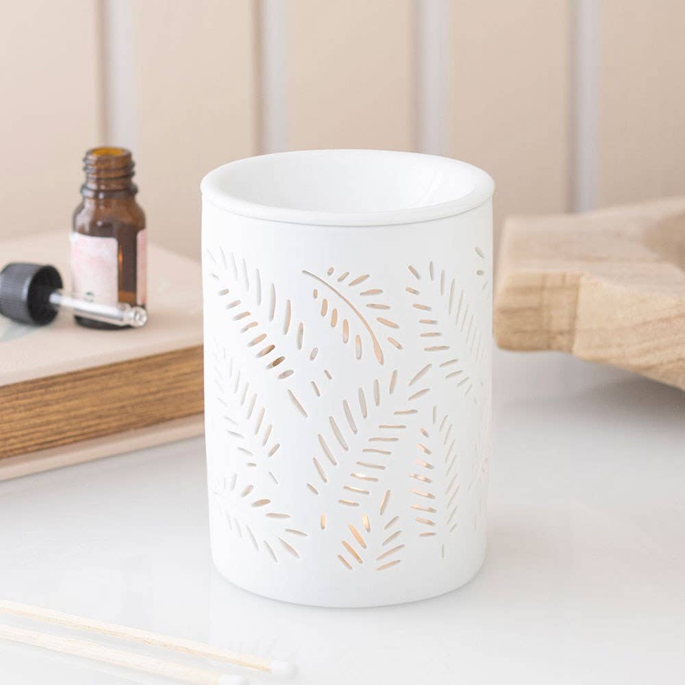 Quemador de cera blanco, con diseño recortado de helecho frondoso